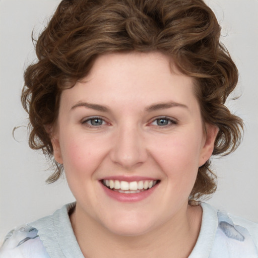 Joyful white young-adult female with medium  brown hair and blue eyes