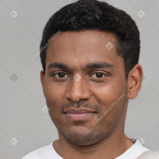 Joyful black young-adult male with short  black hair and brown eyes