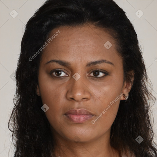 Joyful black young-adult female with long  brown hair and brown eyes