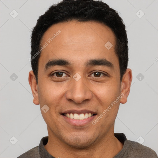 Joyful latino young-adult male with short  black hair and brown eyes