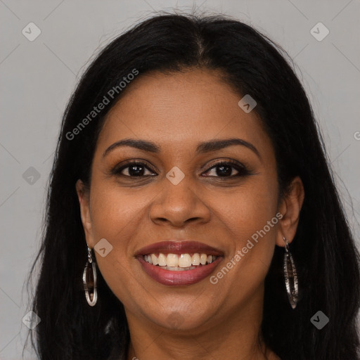 Joyful black young-adult female with long  brown hair and brown eyes