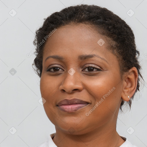 Joyful black young-adult female with short  brown hair and brown eyes