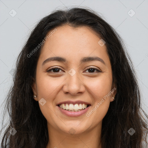 Joyful latino young-adult female with long  brown hair and brown eyes