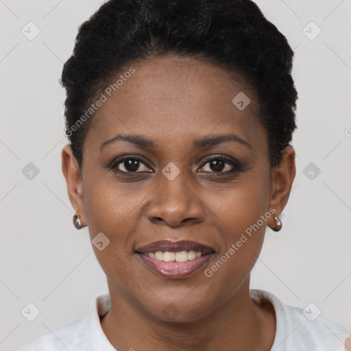 Joyful black young-adult female with short  black hair and brown eyes