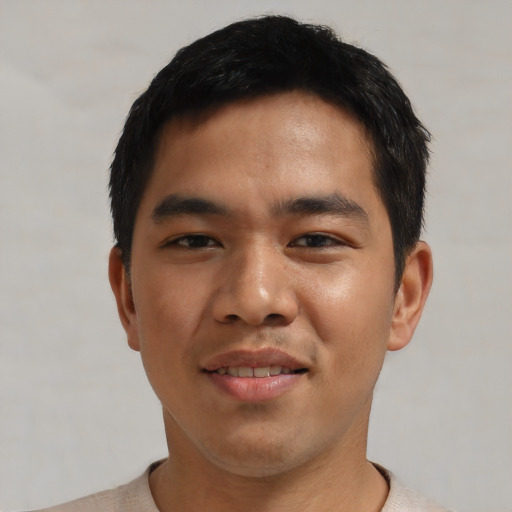 Joyful asian young-adult male with short  black hair and brown eyes