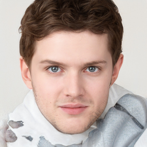 Joyful white young-adult male with short  brown hair and blue eyes