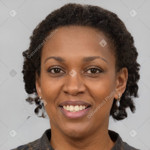 Joyful black adult female with medium  brown hair and brown eyes
