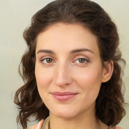 Joyful white young-adult female with medium  brown hair and green eyes