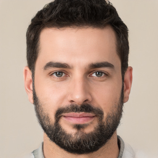 Joyful white young-adult male with short  black hair and brown eyes