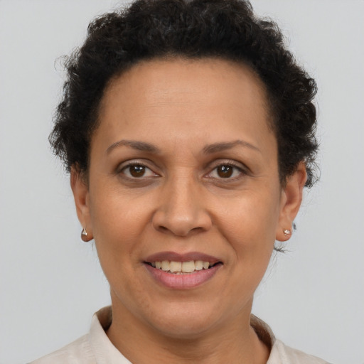 Joyful latino adult female with short  brown hair and brown eyes