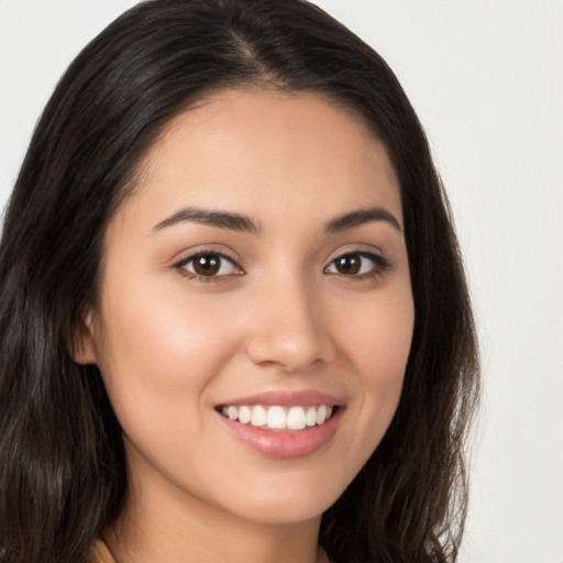 Joyful white young-adult female with long  brown hair and brown eyes