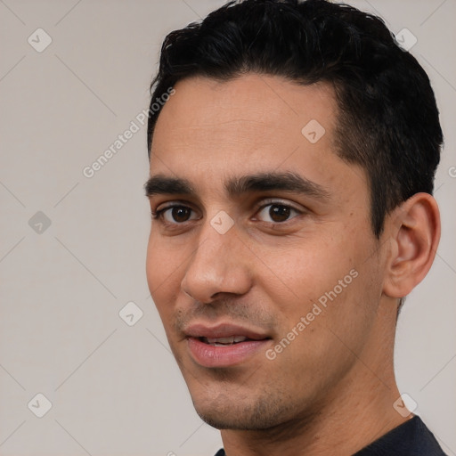 Joyful white young-adult male with short  black hair and brown eyes