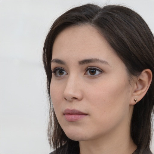 Neutral white young-adult female with long  brown hair and brown eyes