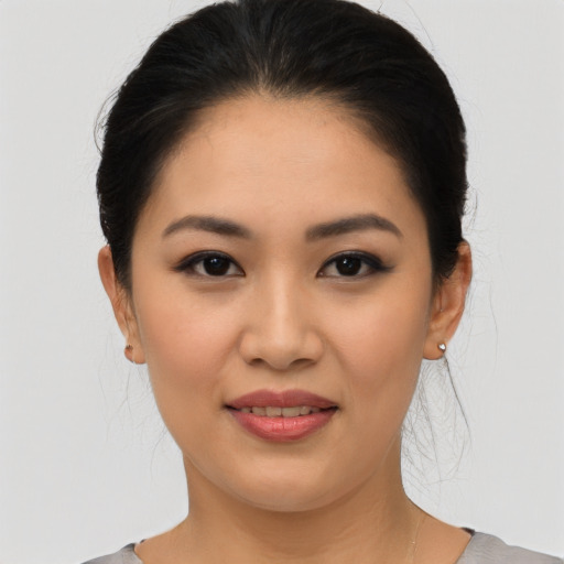 Joyful asian young-adult female with medium  black hair and brown eyes