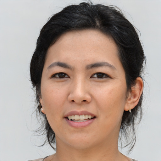 Joyful asian young-adult female with medium  black hair and brown eyes