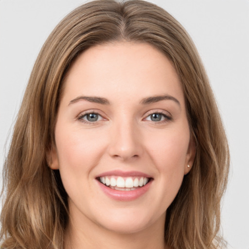 Joyful white young-adult female with long  brown hair and green eyes