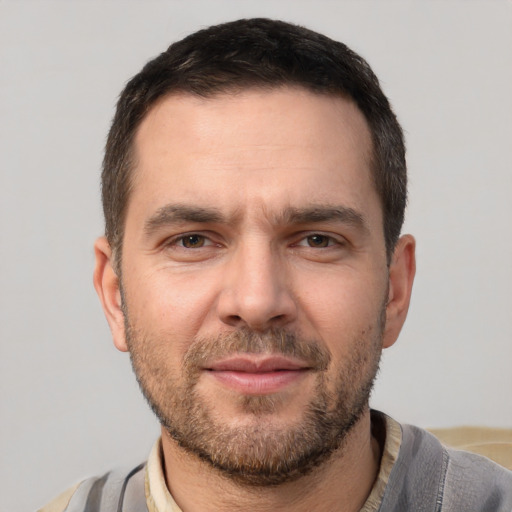 Joyful white adult male with short  brown hair and brown eyes