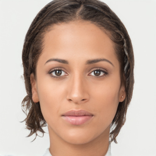 Joyful latino young-adult female with medium  brown hair and brown eyes