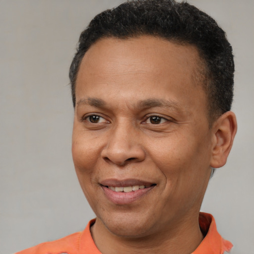 Joyful latino adult male with short  brown hair and brown eyes