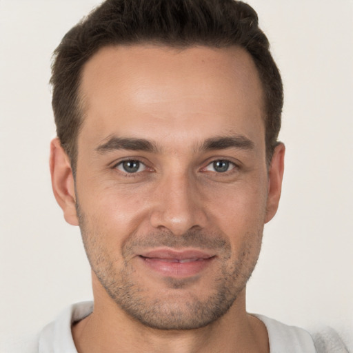 Joyful white adult male with short  brown hair and brown eyes