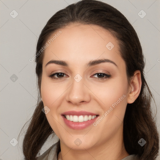 Joyful white young-adult female with long  brown hair and brown eyes