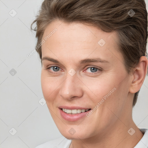 Joyful white young-adult female with short  brown hair and brown eyes