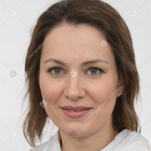 Joyful white adult female with medium  brown hair and grey eyes