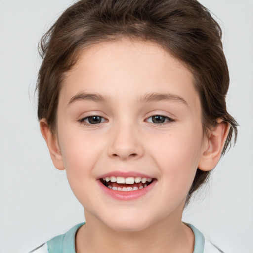 Joyful white child female with short  brown hair and brown eyes