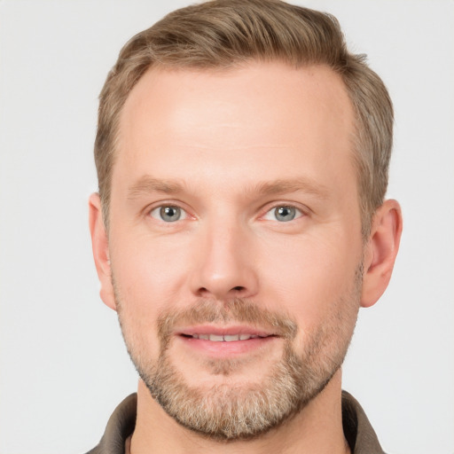 Joyful white adult male with short  brown hair and grey eyes