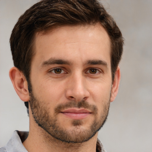 Joyful white young-adult male with short  brown hair and brown eyes