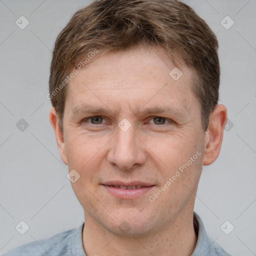 Joyful white adult male with short  brown hair and grey eyes