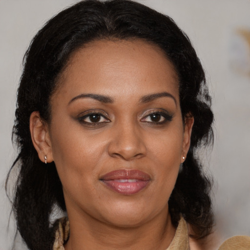 Joyful black adult female with medium  brown hair and brown eyes