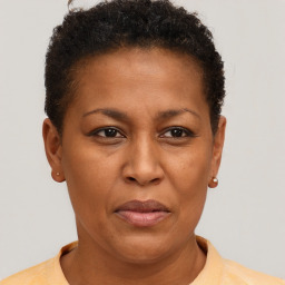 Joyful black adult female with short  brown hair and brown eyes