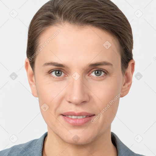 Joyful white young-adult female with short  brown hair and grey eyes