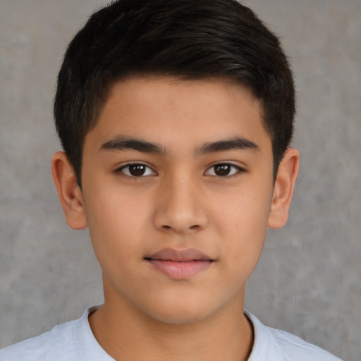 Joyful latino child male with short  brown hair and brown eyes