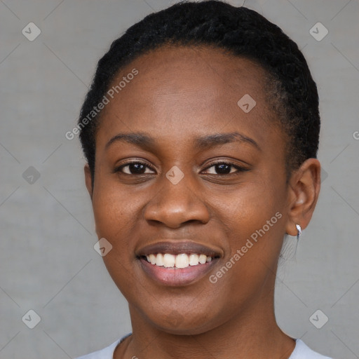 Joyful black young-adult female with short  black hair and brown eyes