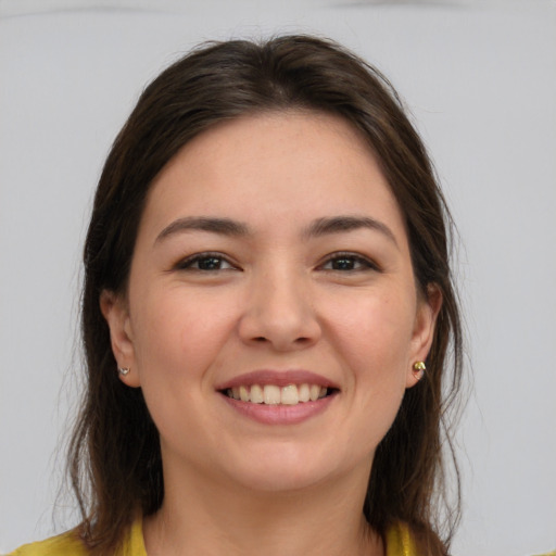 Joyful white young-adult female with medium  brown hair and brown eyes