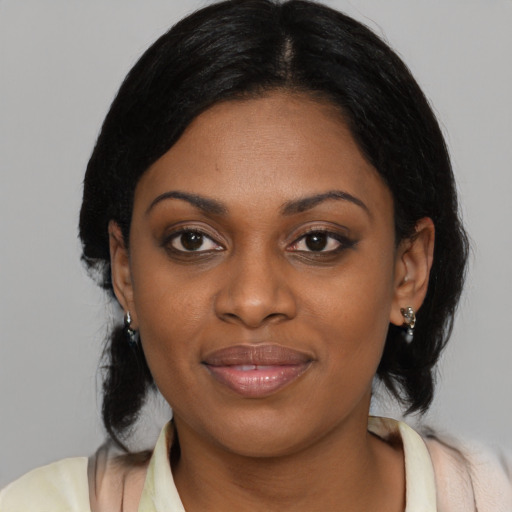 Joyful black young-adult female with medium  black hair and brown eyes