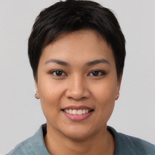 Joyful asian young-adult female with short  black hair and brown eyes
