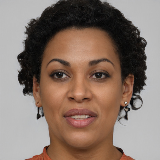 Joyful black young-adult female with short  brown hair and brown eyes