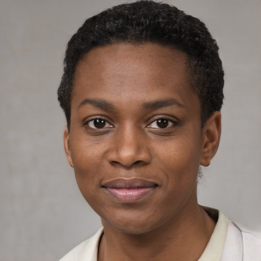 Joyful black young-adult female with short  black hair and brown eyes
