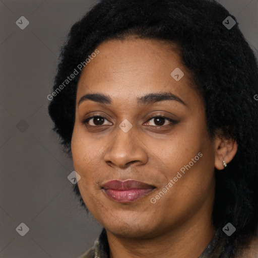 Joyful black young-adult female with long  black hair and brown eyes