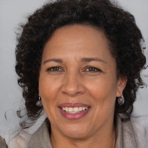 Joyful black adult female with medium  brown hair and brown eyes