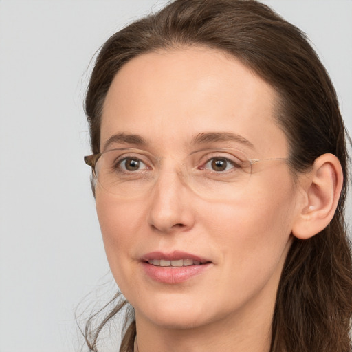 Joyful white adult female with long  brown hair and grey eyes