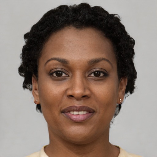 Joyful black adult female with short  brown hair and brown eyes