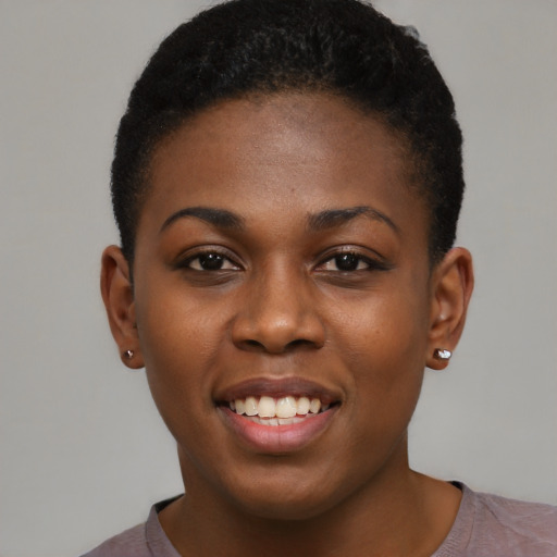 Joyful black young-adult female with short  brown hair and brown eyes