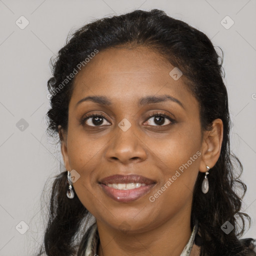 Joyful black adult female with long  brown hair and brown eyes