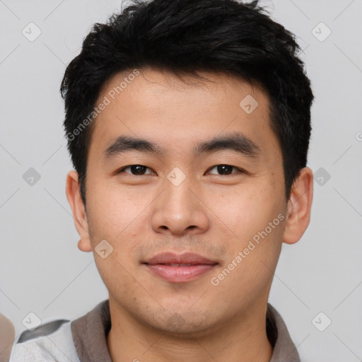 Joyful asian young-adult male with short  brown hair and brown eyes