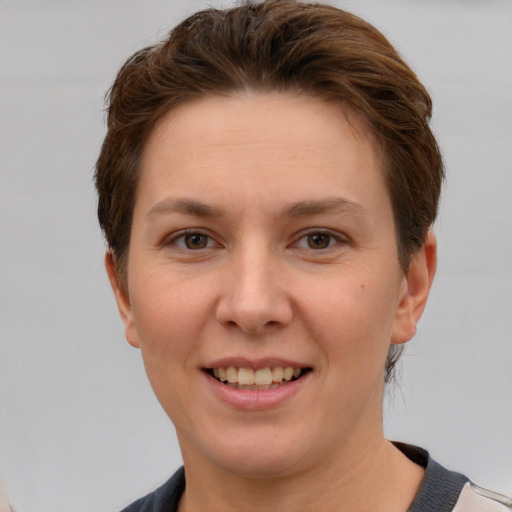 Joyful white young-adult female with short  brown hair and grey eyes