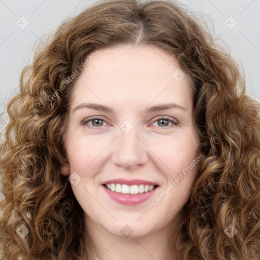 Joyful white young-adult female with long  brown hair and green eyes